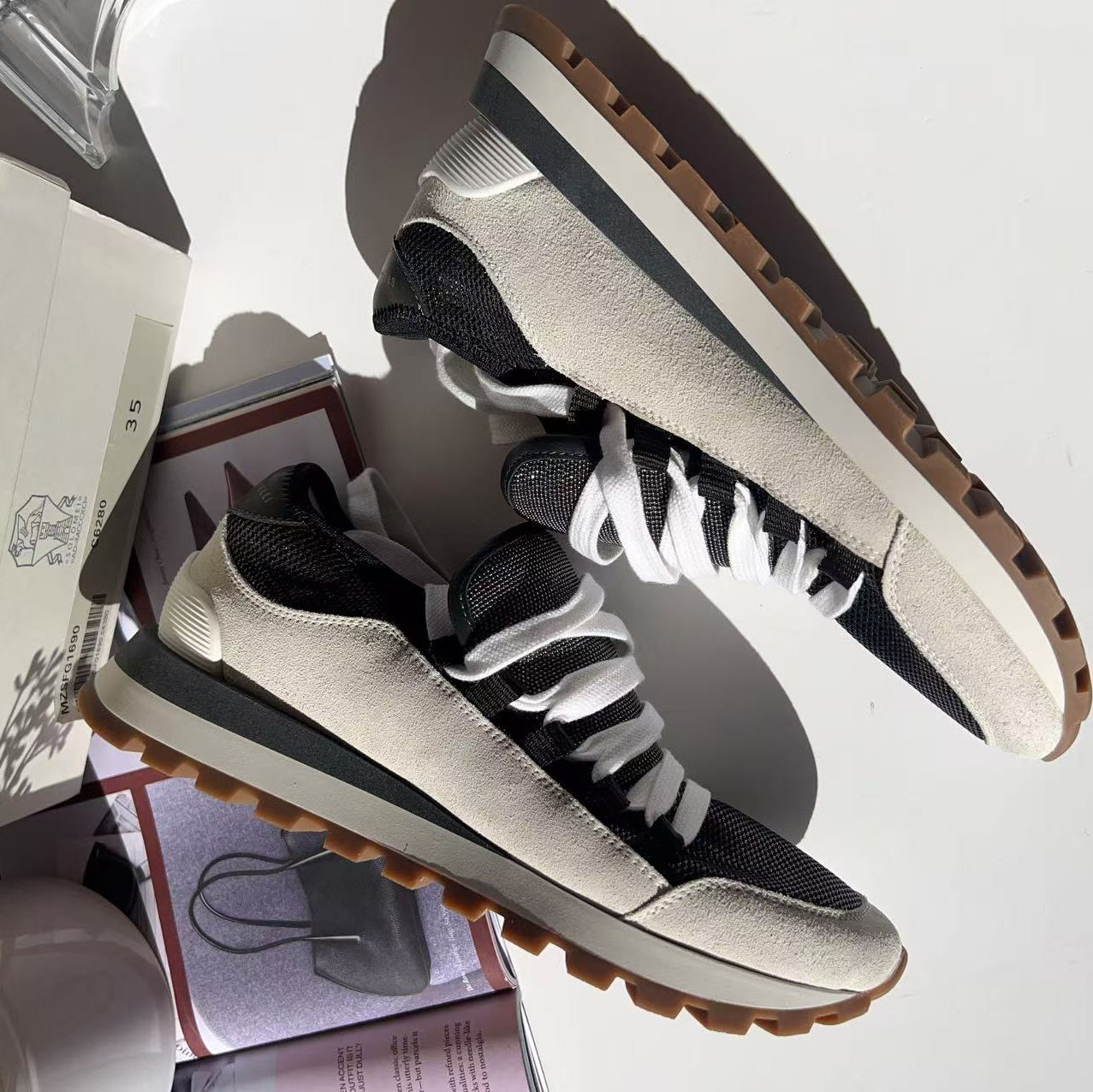 Black and white sneakers with brown soles