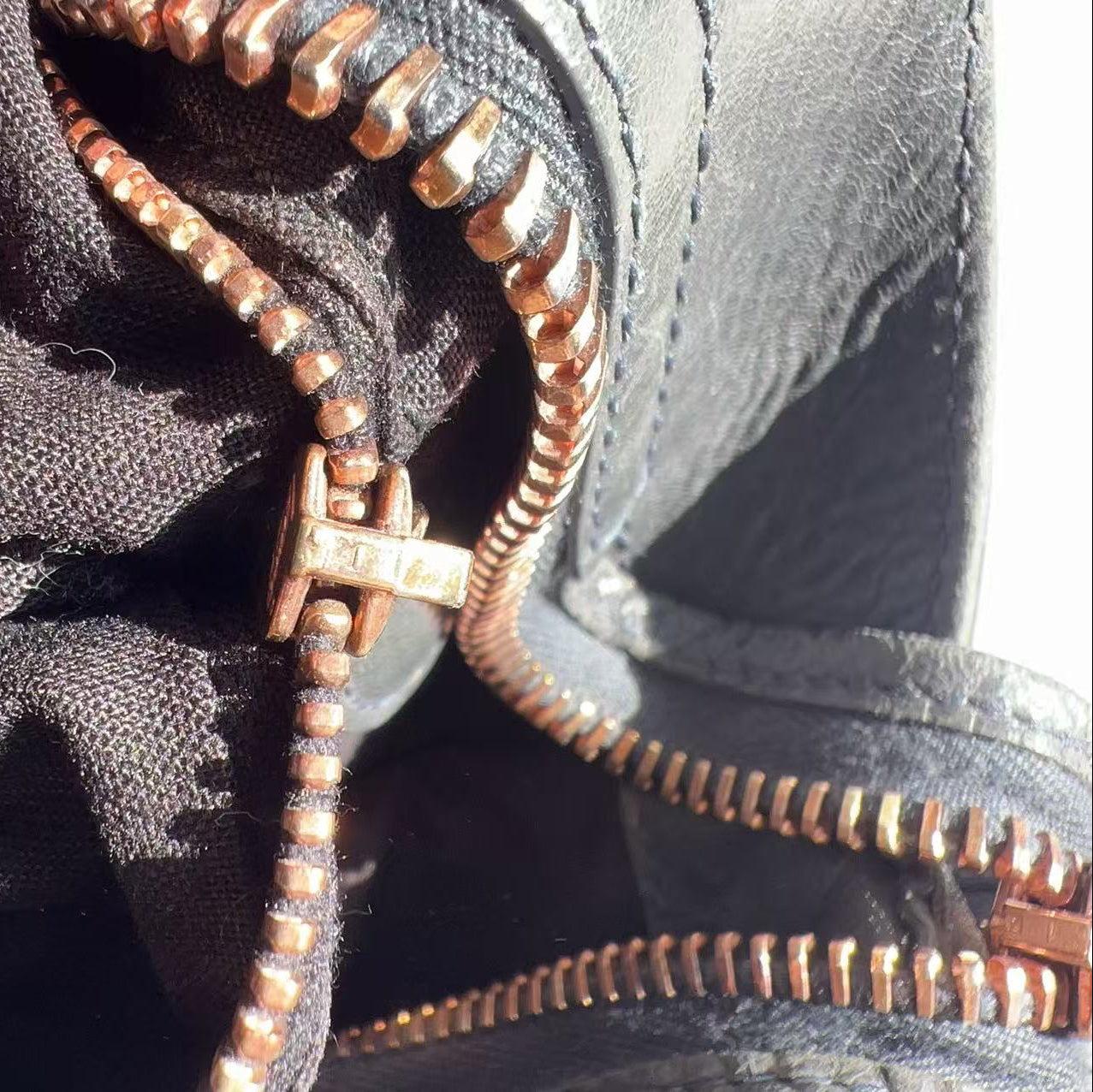 Close-up of a zipper on a textured fabric surface