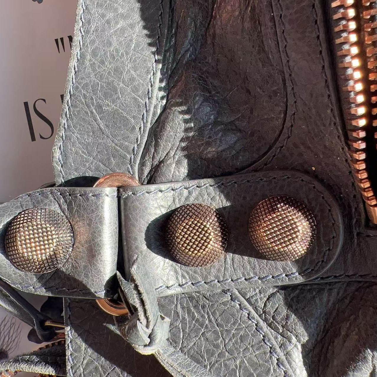 Close-up of a textured leather bag with metal clasps