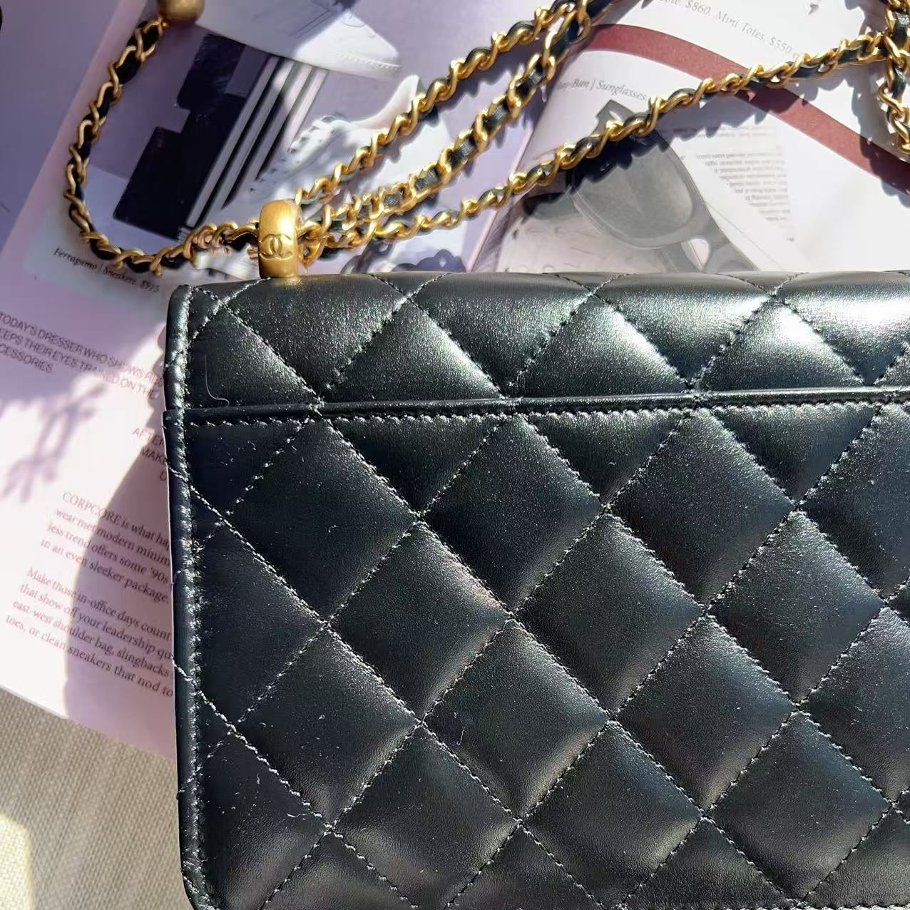 Black quilted handbag with gold chain strap
