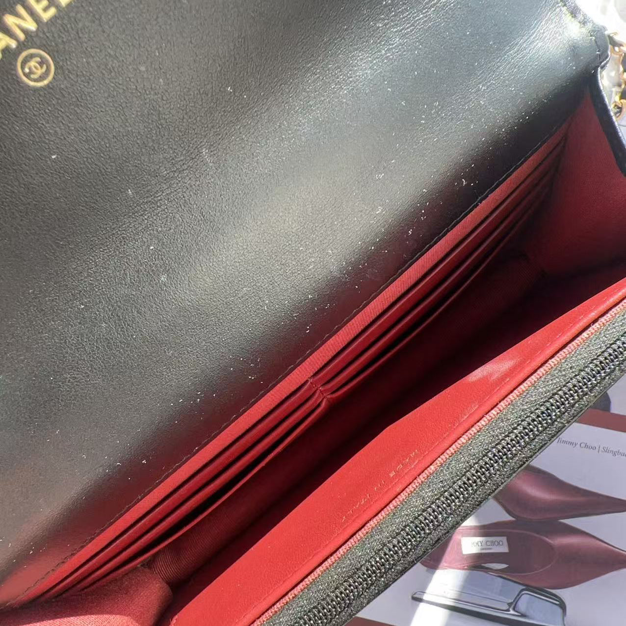 Close-up of a black and red Chanel wallet