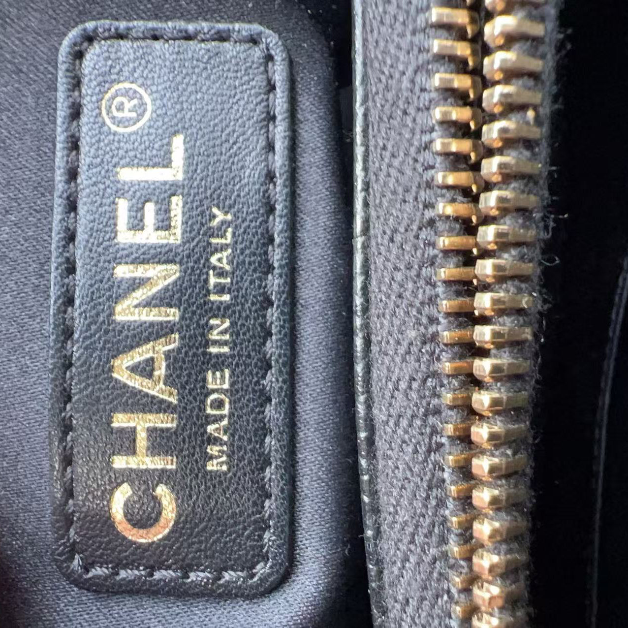 Close-up of a Chanel label on a product with 'Made in Italy' text.