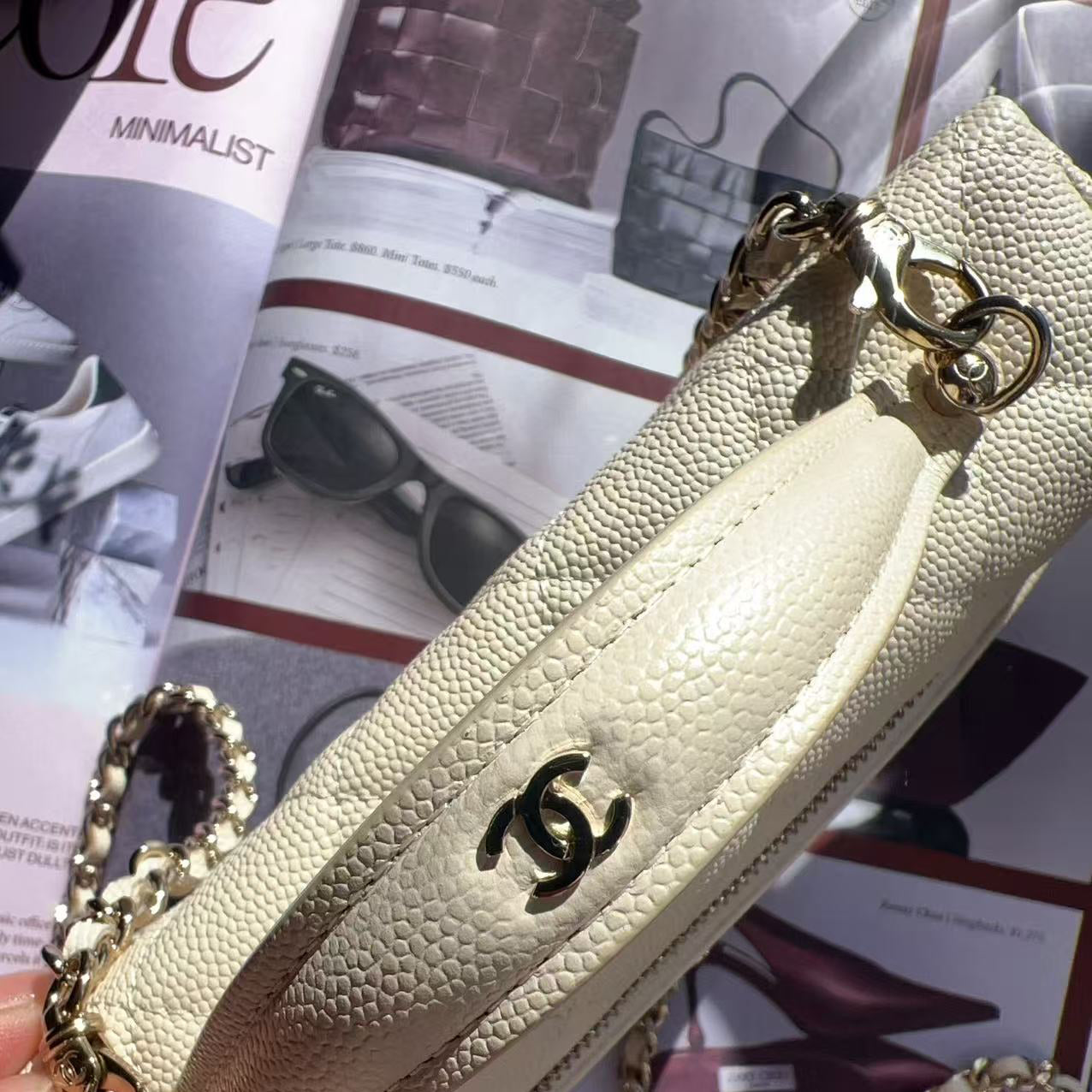 Beige handbag with gold chain and Chanel logo