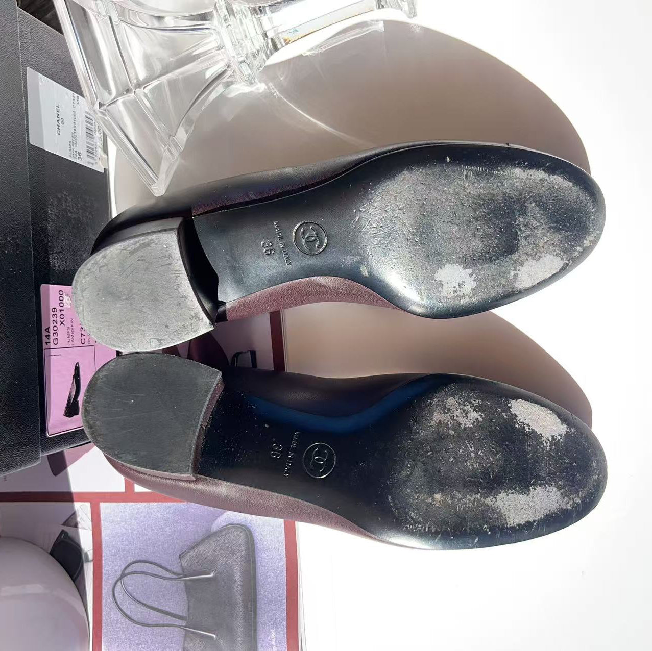 Close-up of a shoe sole with visible wear and a box in the background