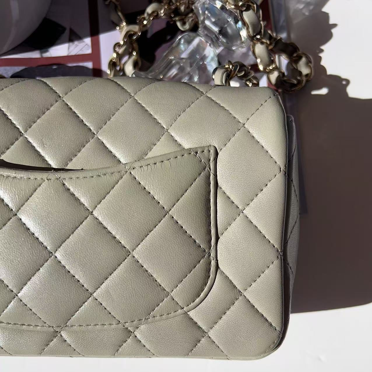 Quilted beige handbag on a white background