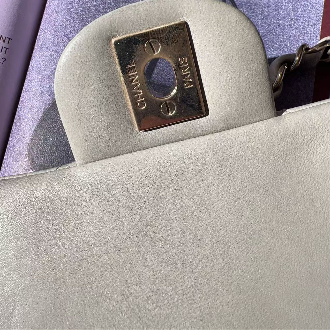 Close-up of a Chanel handbag with the brand logo on a magazine background
