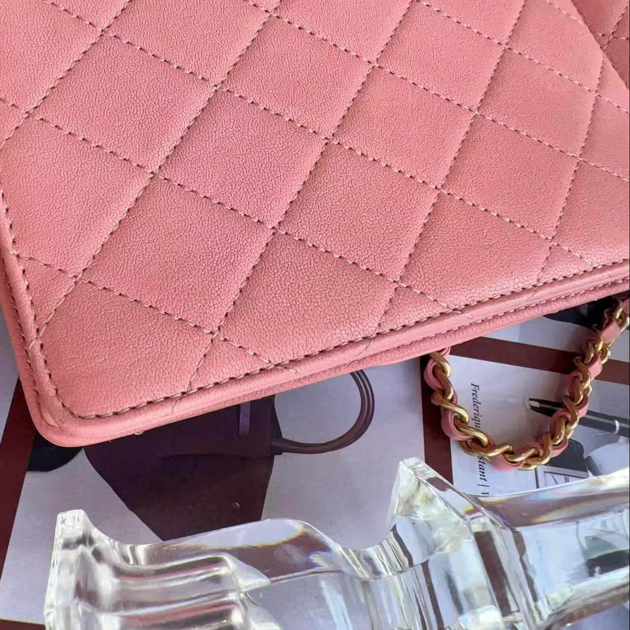 Chanel Pink quilted handbag on a surface with sunglasses