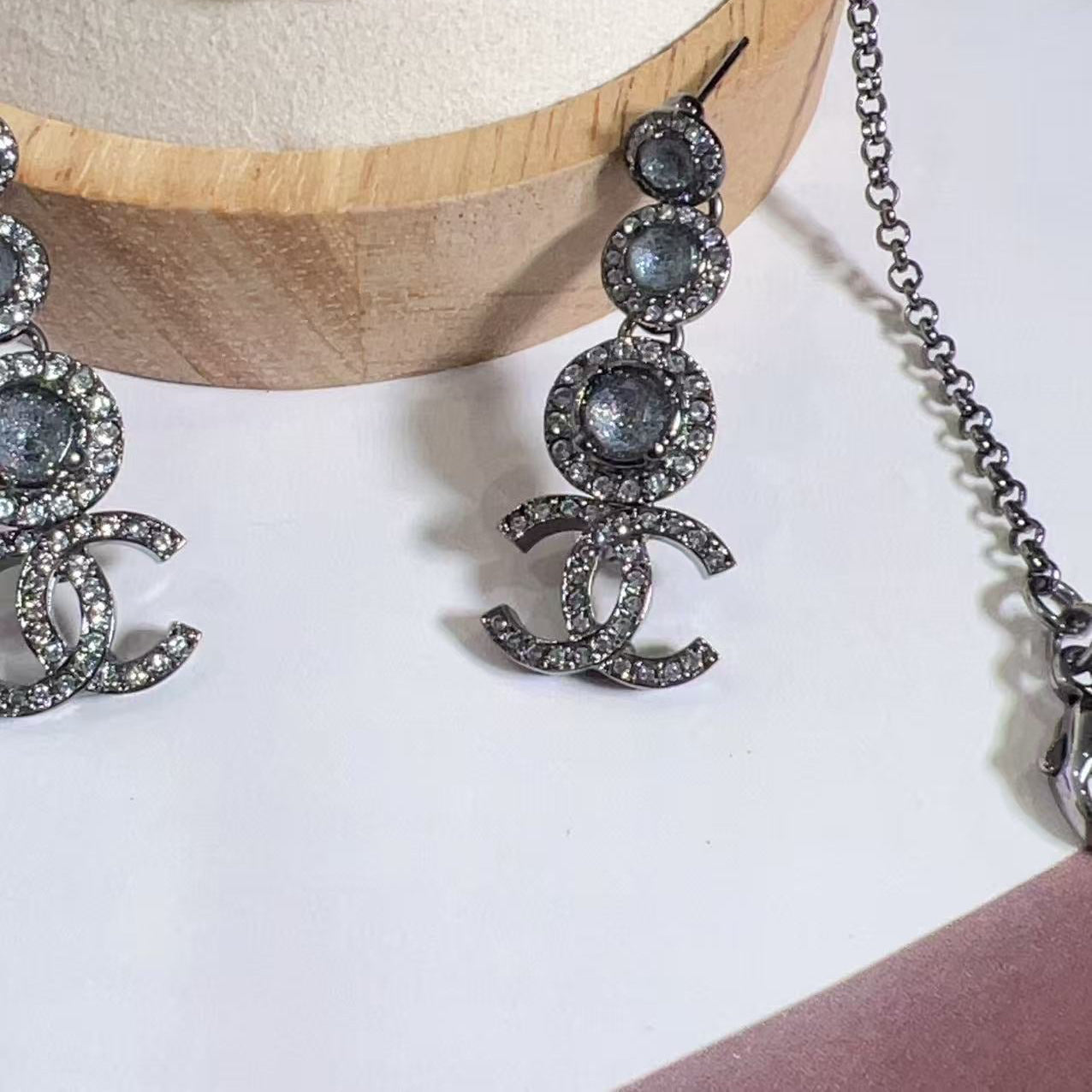 Silver earrings with gemstones on a white surface