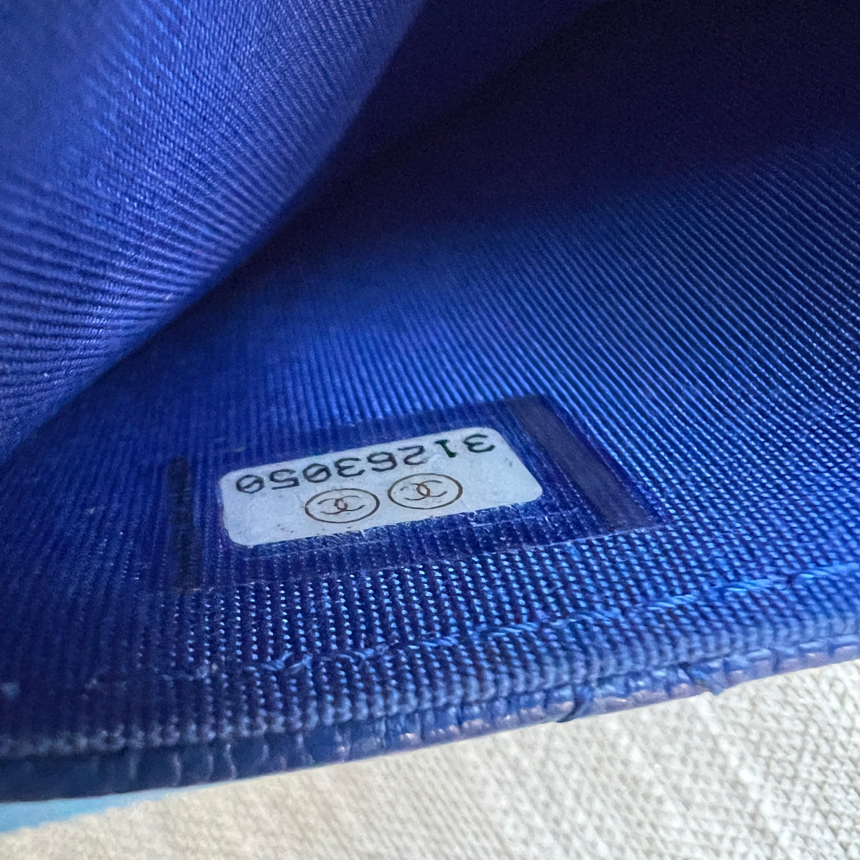 Close-up of a blue fabric with a visible label on a white background