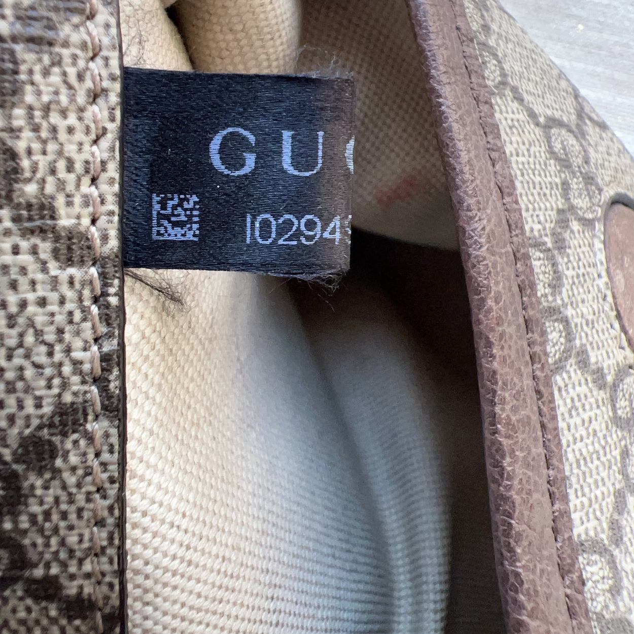 Close-up of a Gucci label on a patterned fabric background