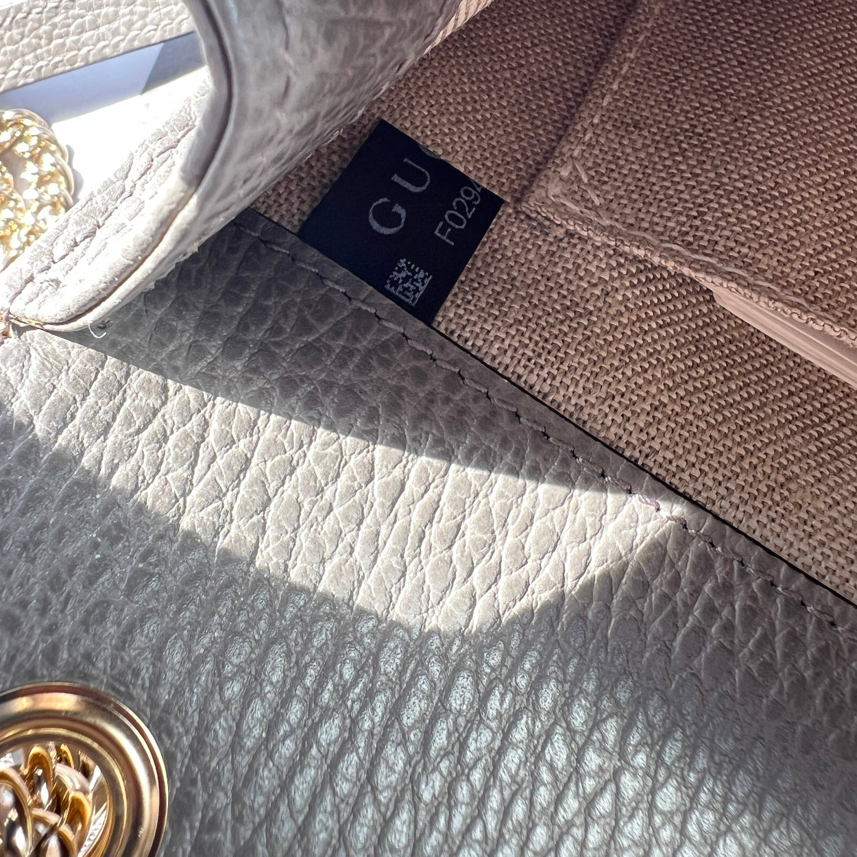 Close-up of a Gucci handbag with a visible logo tag.