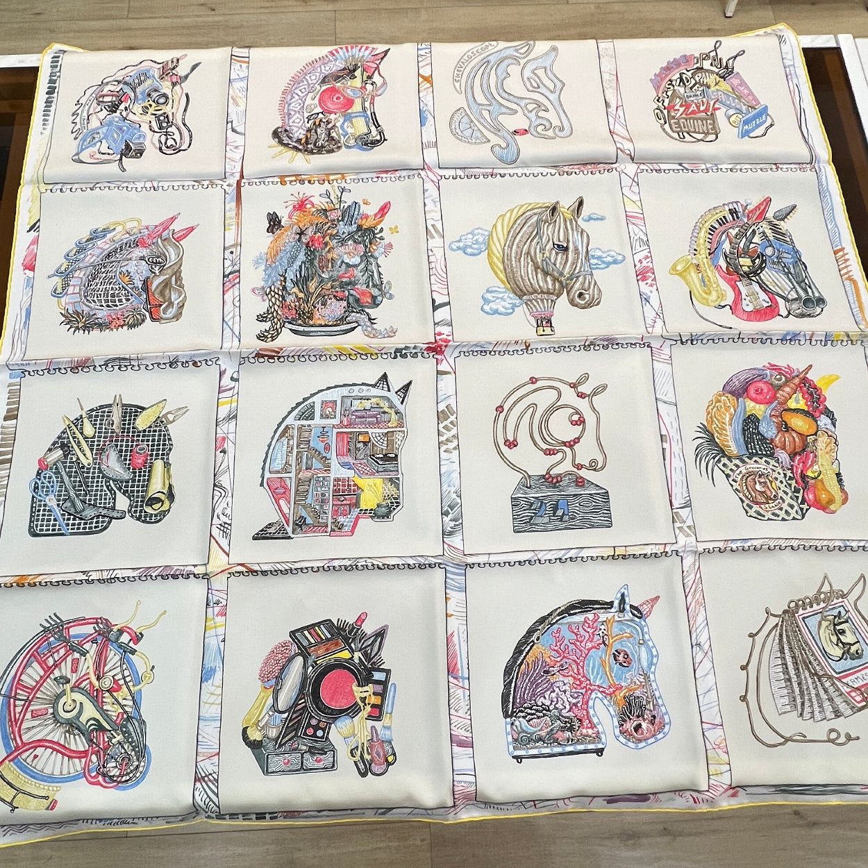Quilt with colorful geometric patterns on a wooden floor.