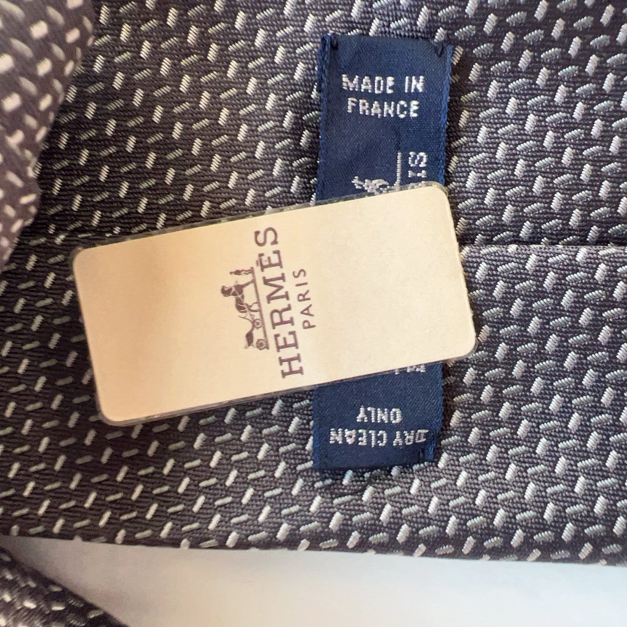 Hermes label on a textured fabric background