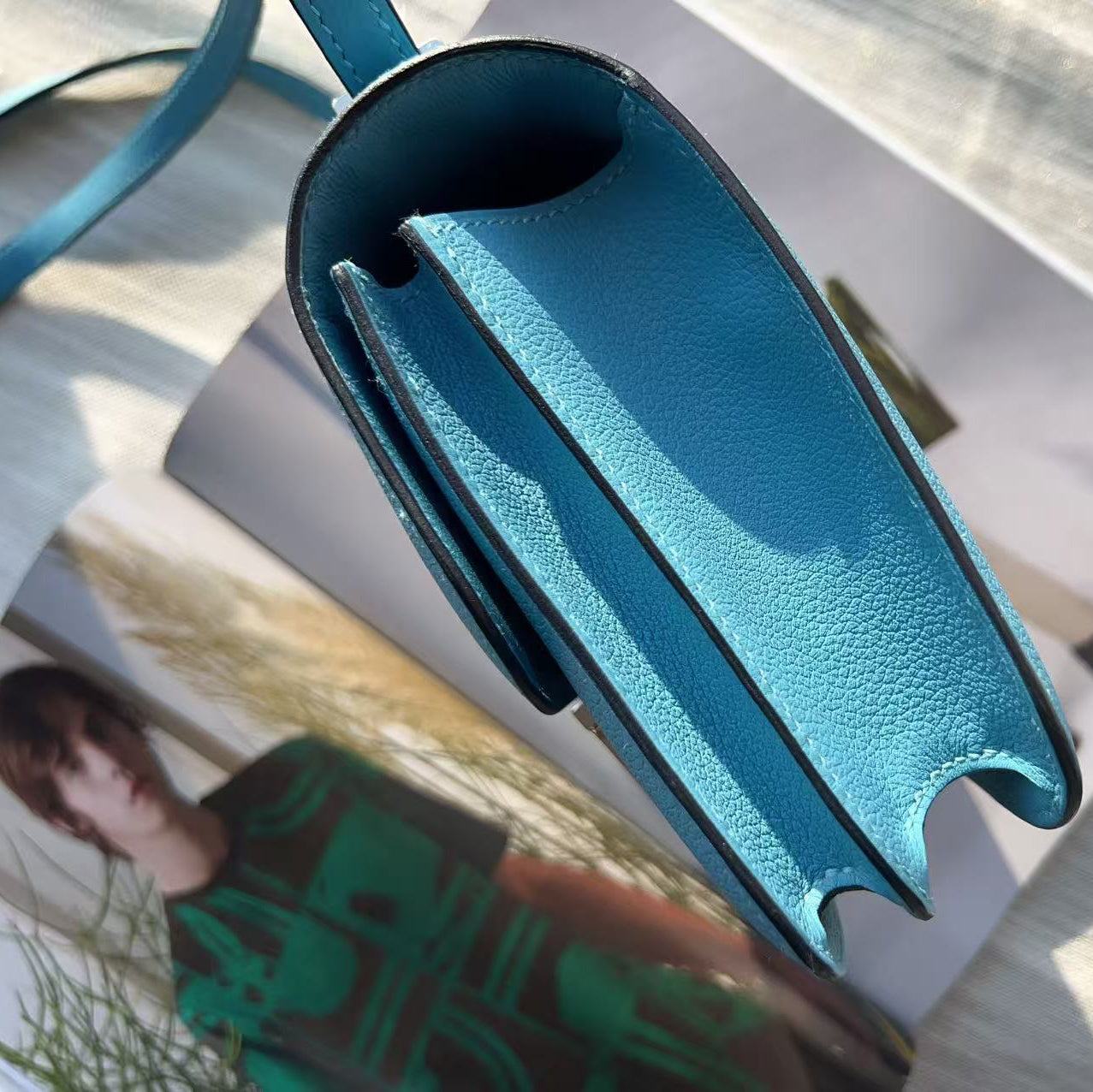 Blue handbag on a magazine