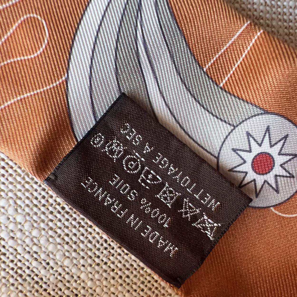 Close-up of a fabric label on a patterned fabric background