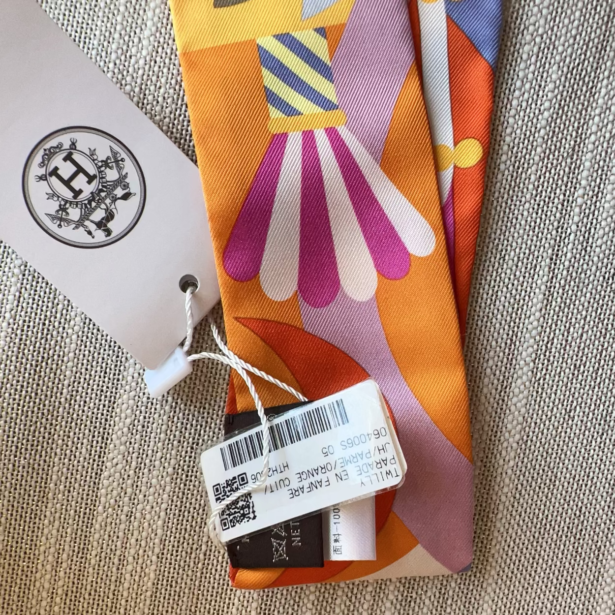 Colorful patterned fabric with a tag on a textured surface