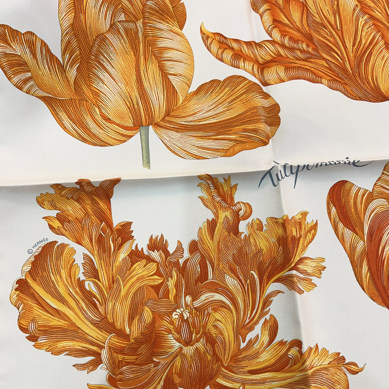 Close-up of a floral pattern with gold leaves on a white background