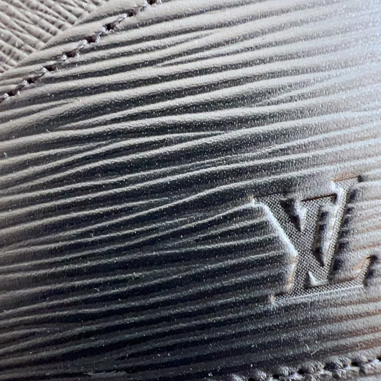 Close-up of a textured surface with a brand logo.