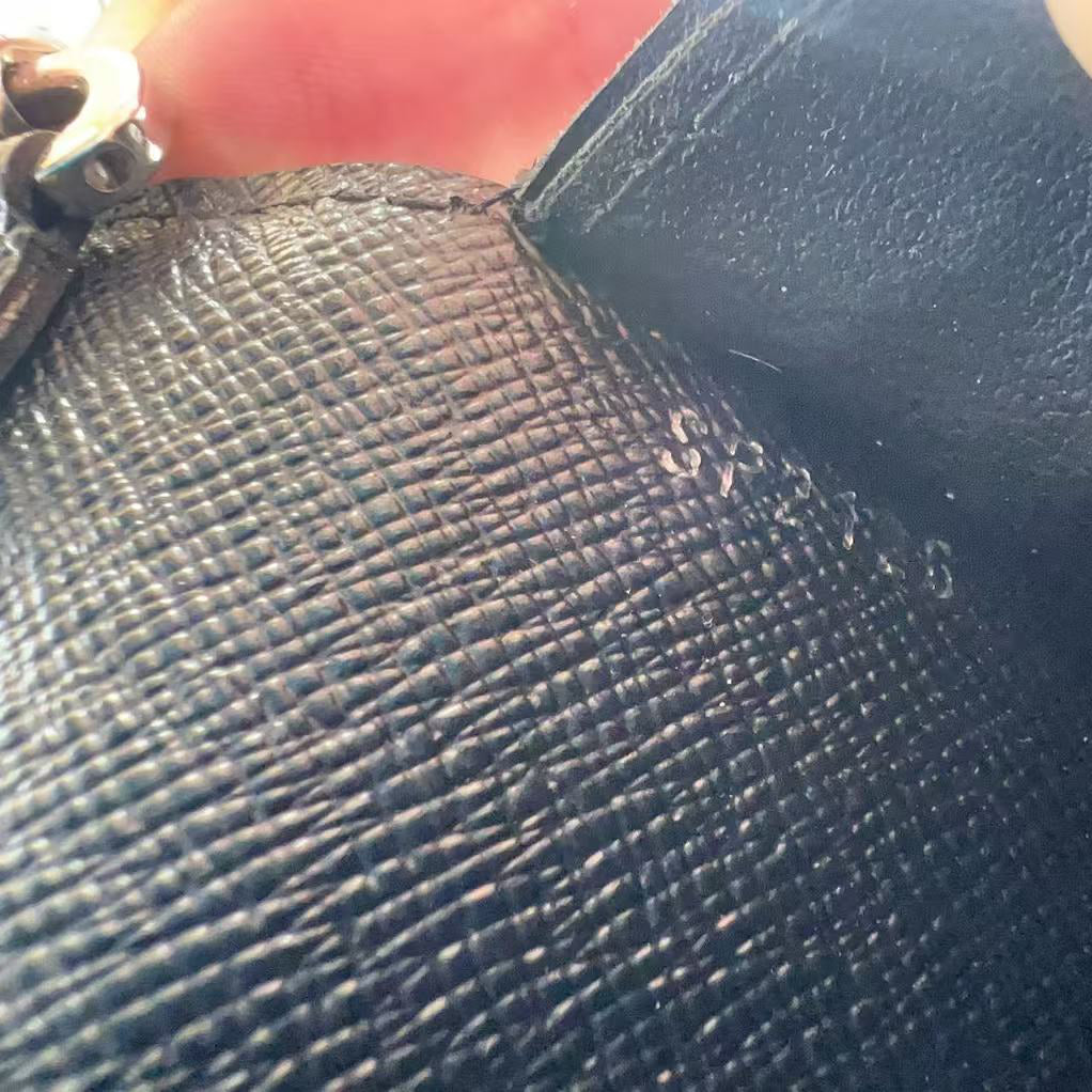 Close-up of a textured black surface with a zipper