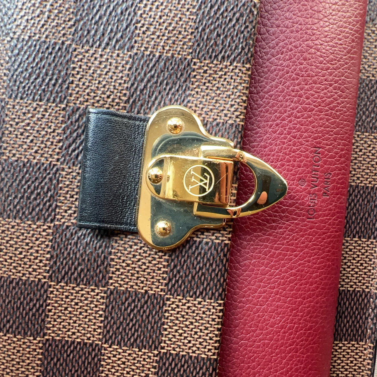 Close-up of a gold lock on a checkered fabric surface