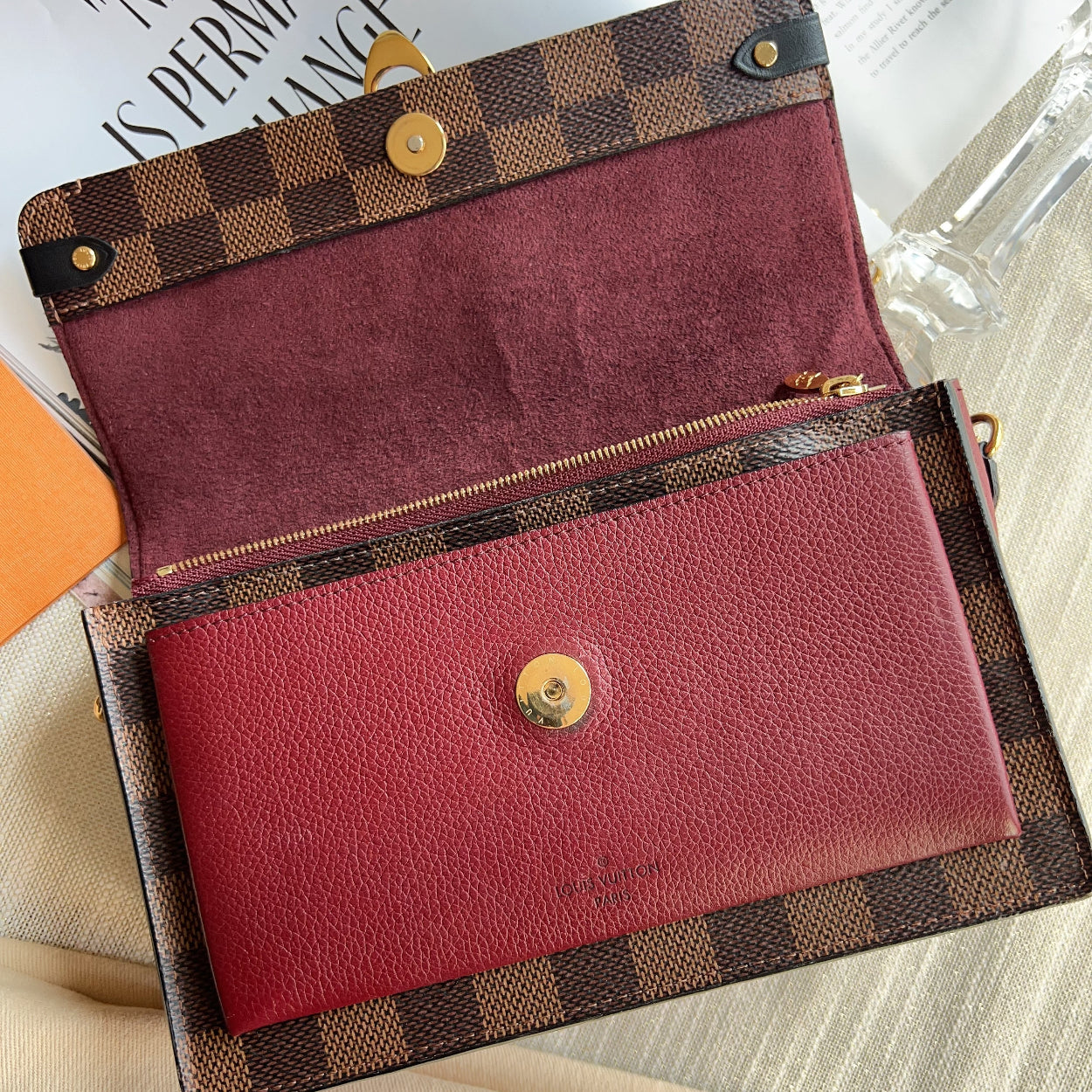 Louis Vuitton wallet with checkered exterior on a surface