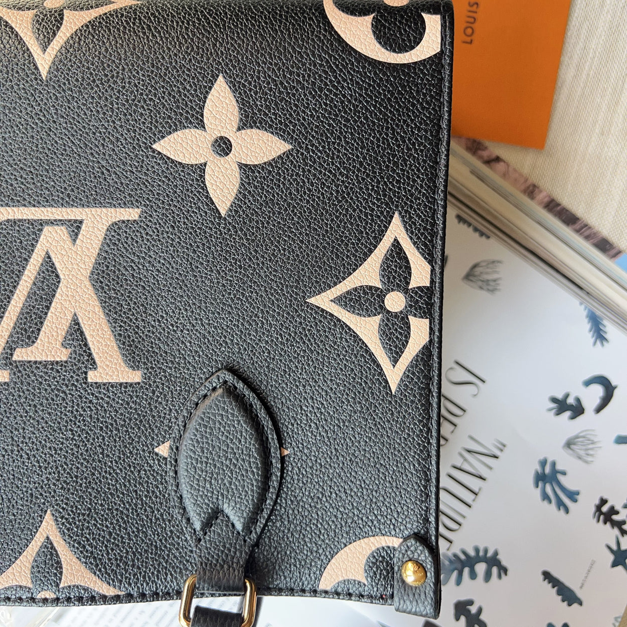 Louis Vuitton handbag with monogram pattern on a surface