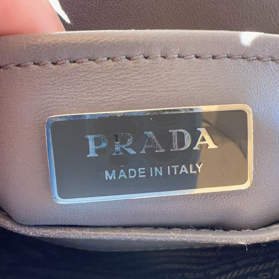 Close-up of a Prada label on a leather product.