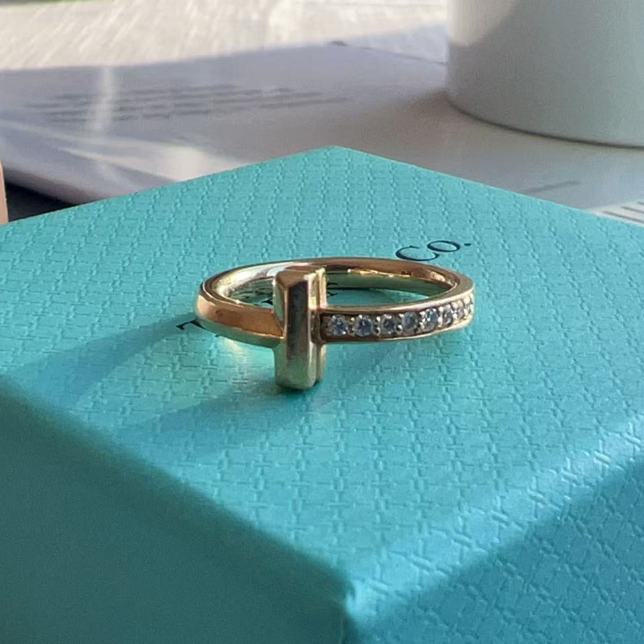 Gold ring with diamonds on a Tiffany & Co. box