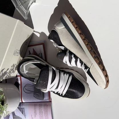 Black and white sneakers on a surface 