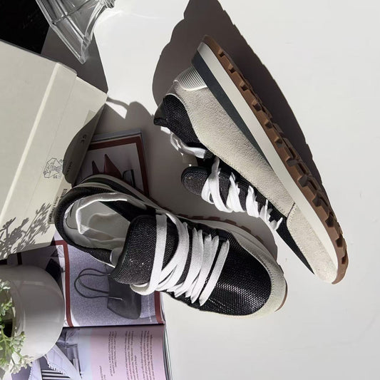 Black and white sneakers on a surface 