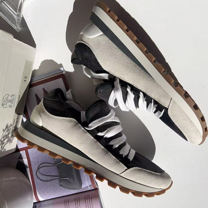 Black and white sneakers with brown soles
