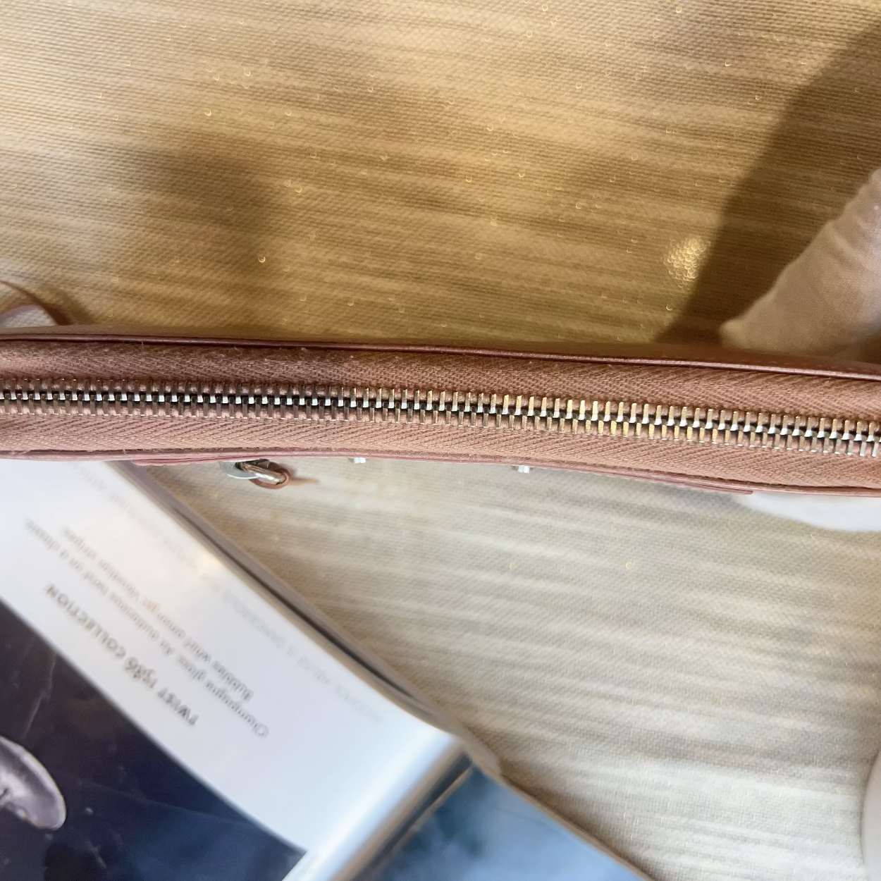 Close-up of a zipper on a surface with a blurred background