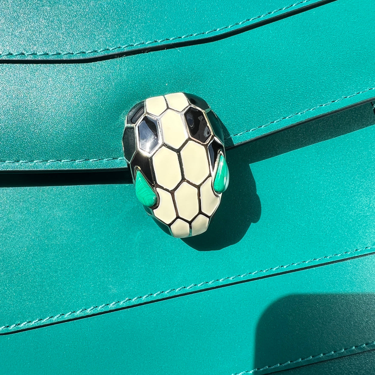 Close-up of a soccer ball design on a teal leather surface