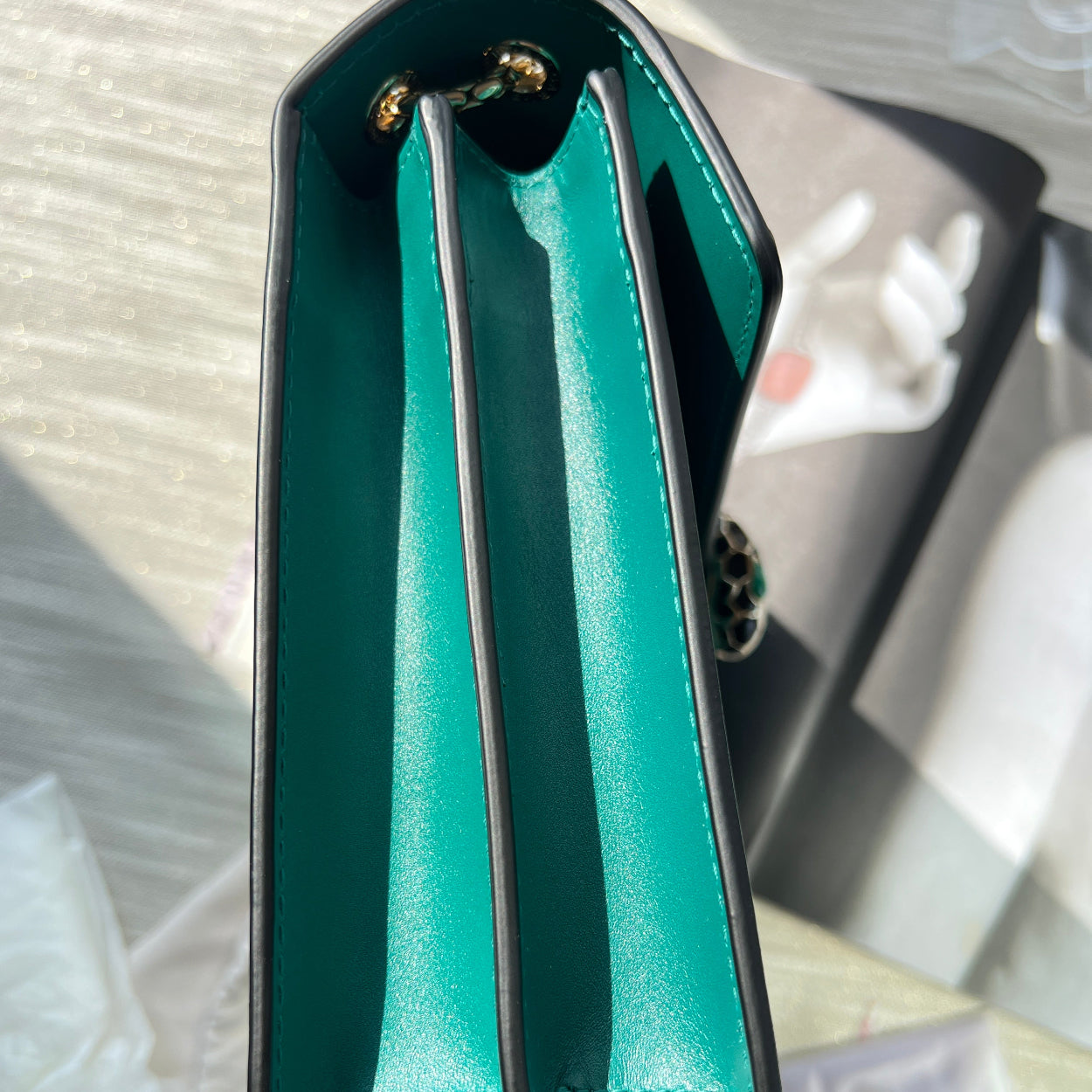 Close-up of a teal wallet with a blurred background