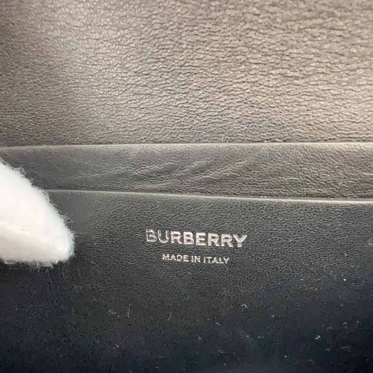 Burberry product with 'Made in Italy' label on a dark background