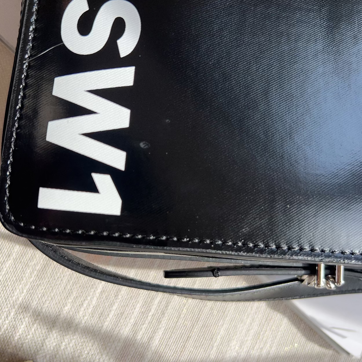 Black bag with 'LMS SW1' branding on a light surface
