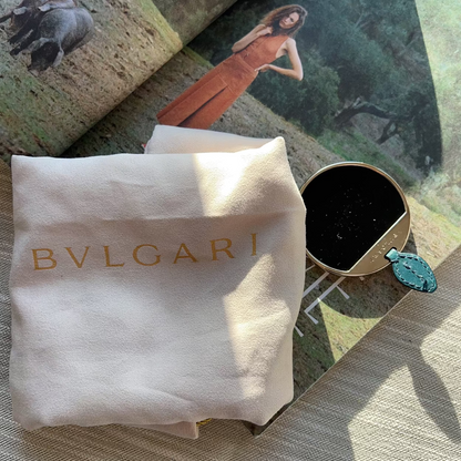 Bulgari jewelry box with a Bulgari pouch on a magazine