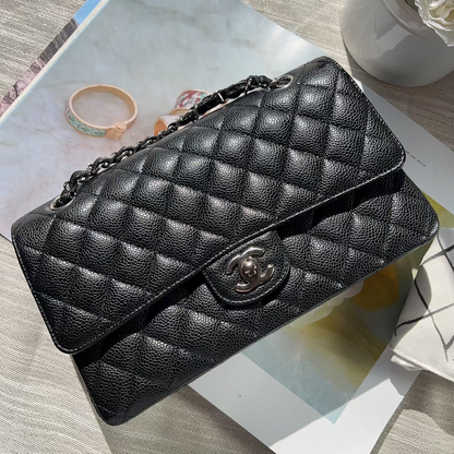 Black quilted handbag on a magazine with a light background