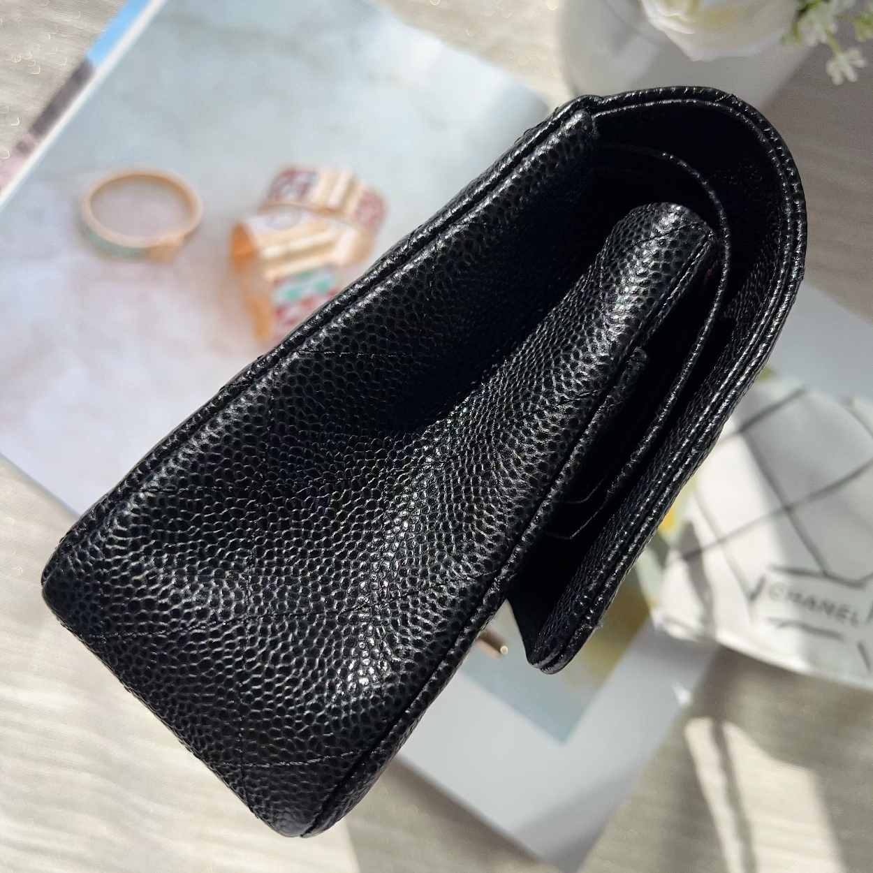 Black leather case on a surface with a blurred background