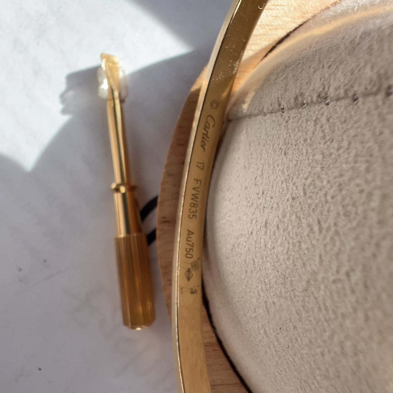 Gold-colored tool on a textured surface