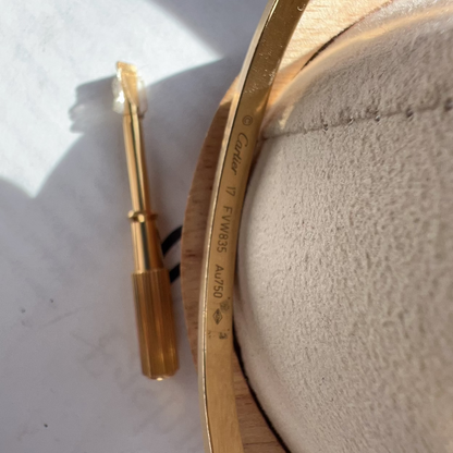 Gold-colored tool on a textured surface