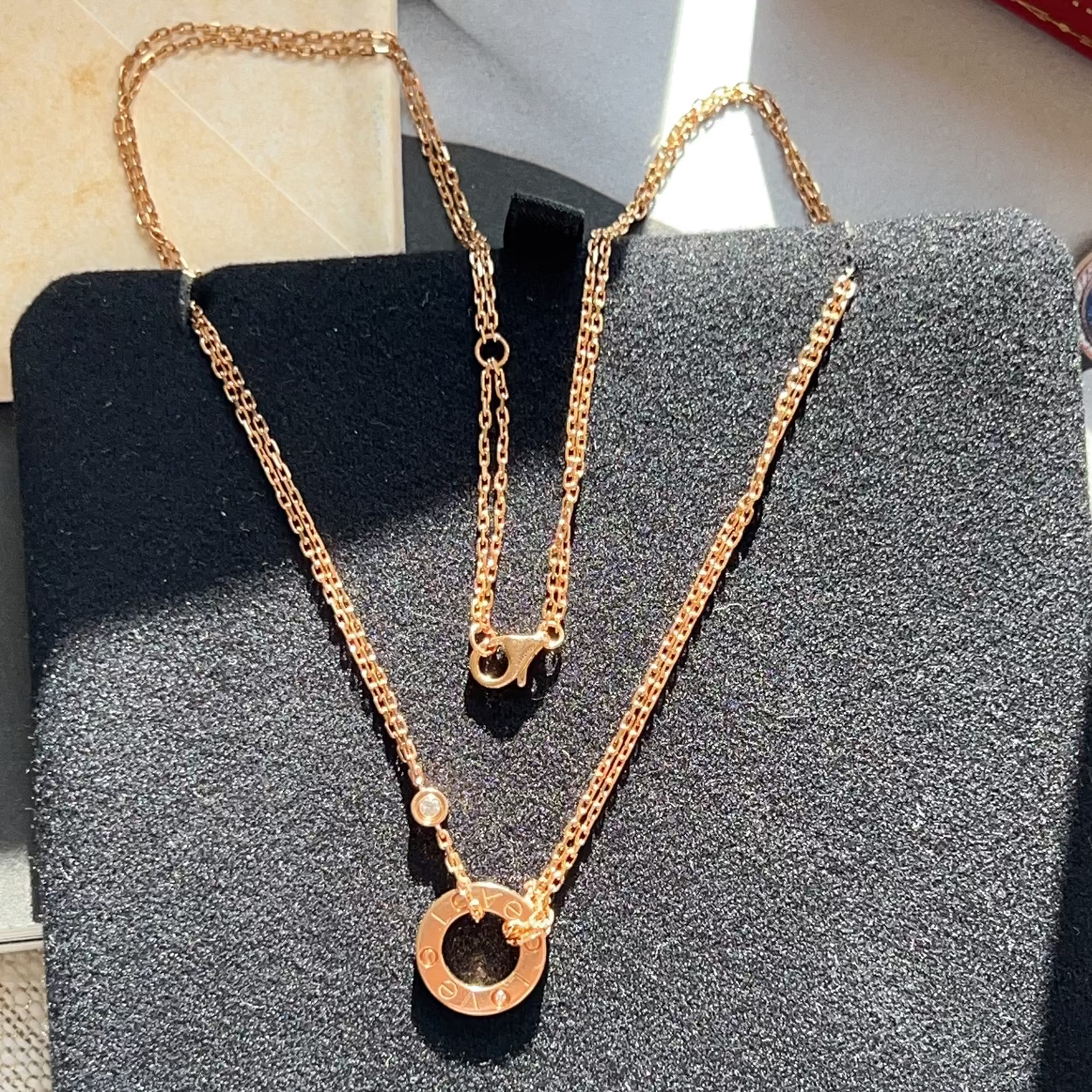 Gold necklace on a textured black surface