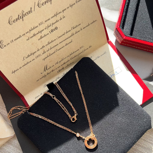 Gold necklace on a black stand with a certificate of authenticity in the background