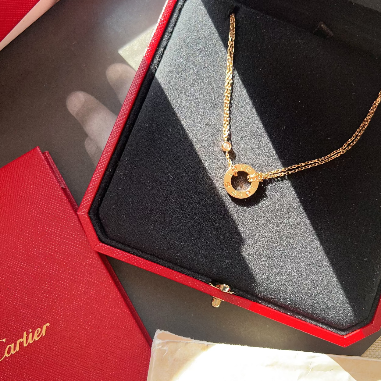 Gold necklace in a Cartier box