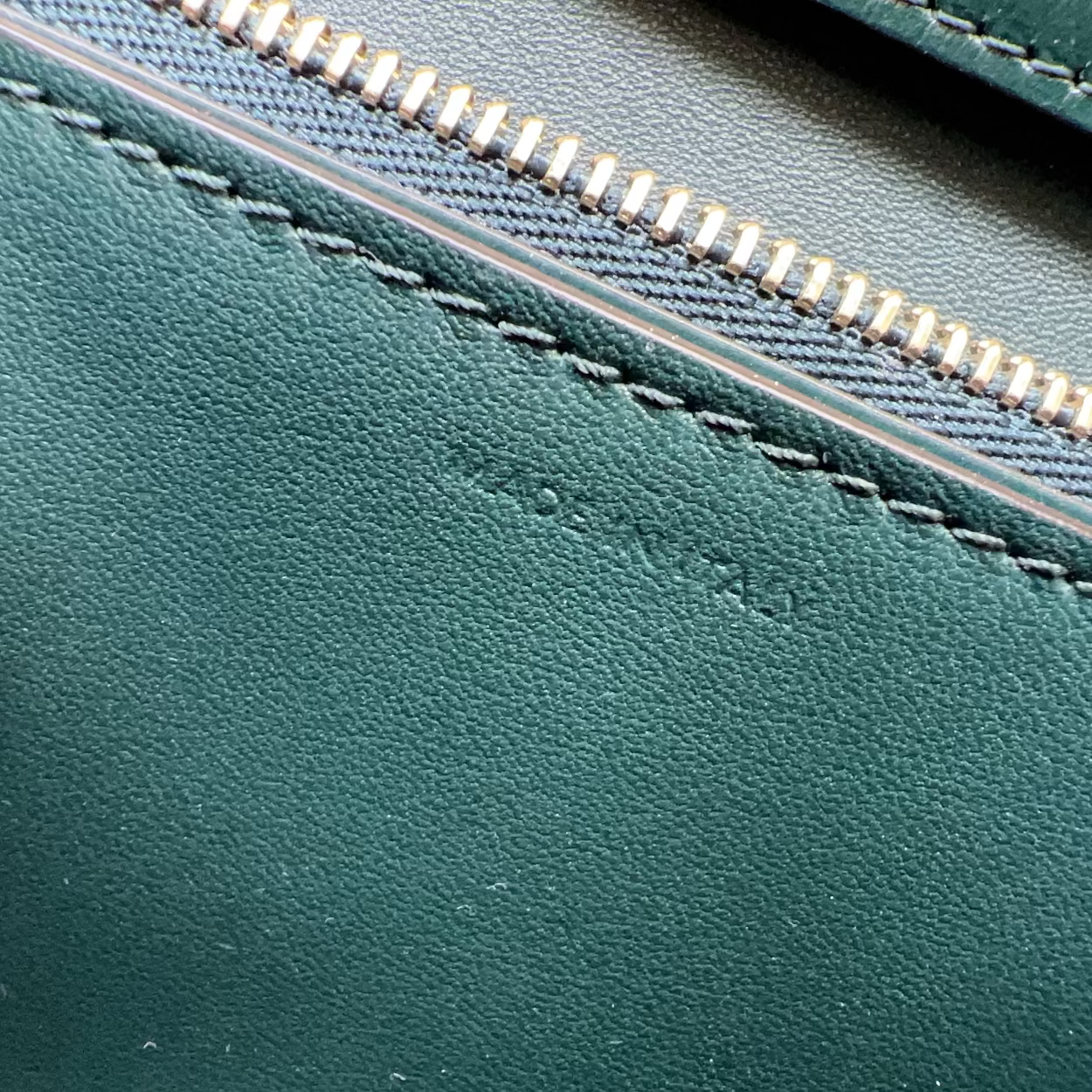 Close-up of green leather with a zipper