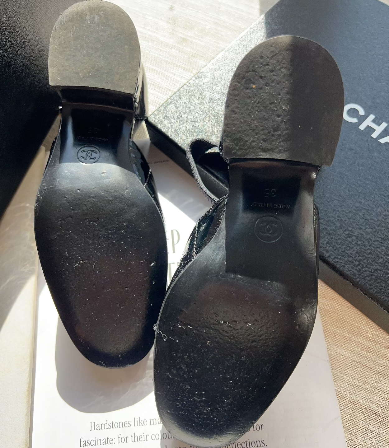 Black shoes with soles showing wear on a magazine