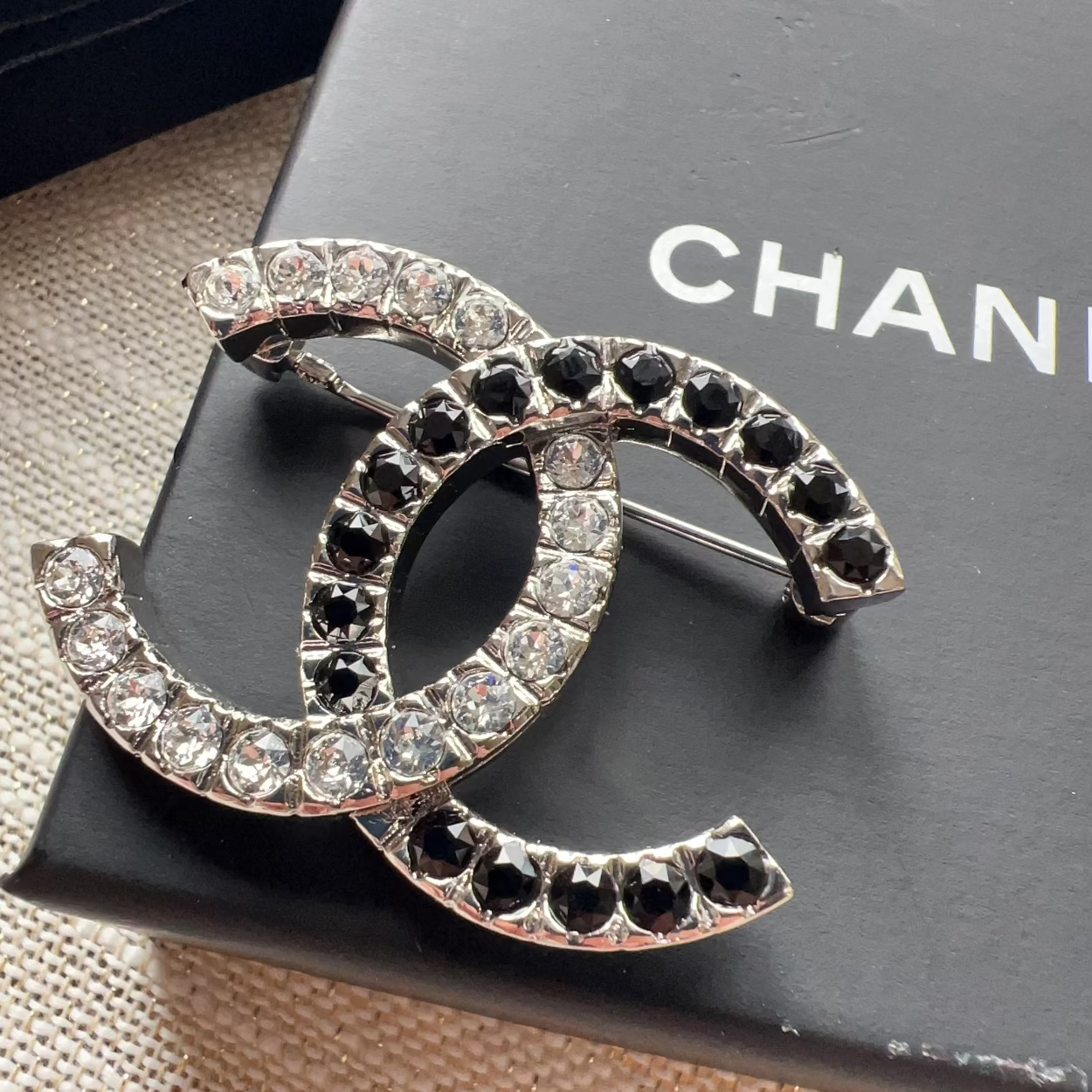 Chanel brooch with crystals on a Chanel box