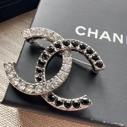Chanel brooch with crystals on a Chanel box