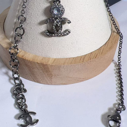Silver necklace with pendant on a wooden stand