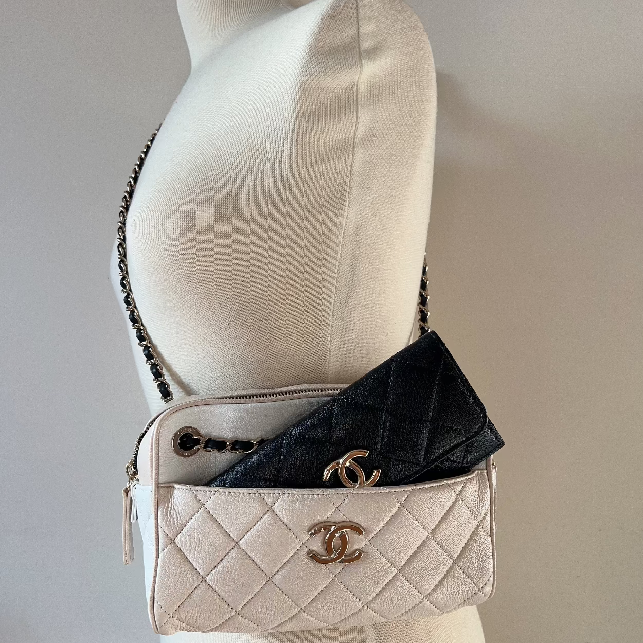 Beige quilted handbag with gold CC logo on a mannequin against a neutral background